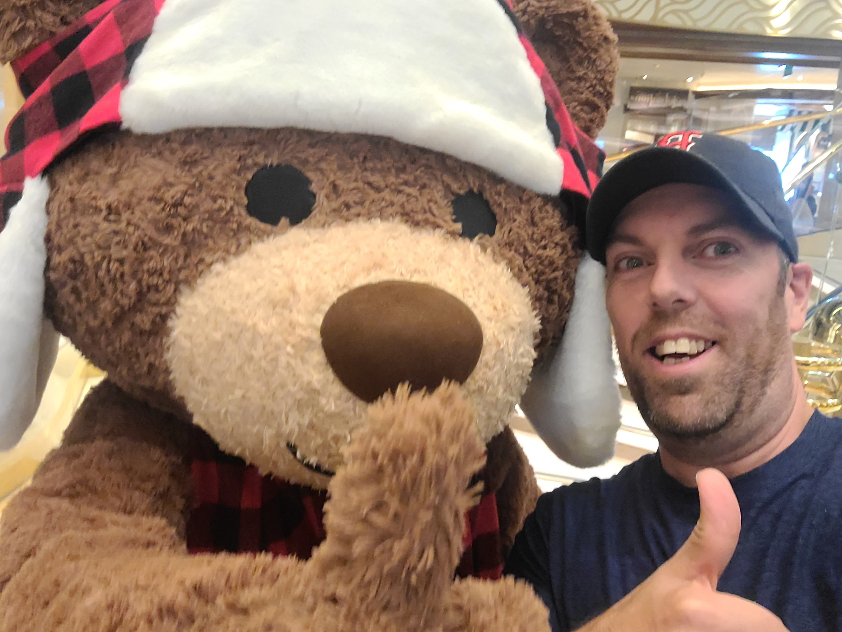 Jim and a bear mascot giving the thumbs up.